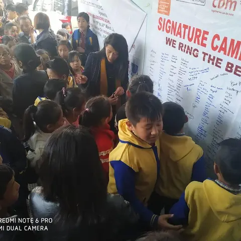 Various school students signing on the Signature Campaign for 'Ring the Bell' activity for RAISE-NE.