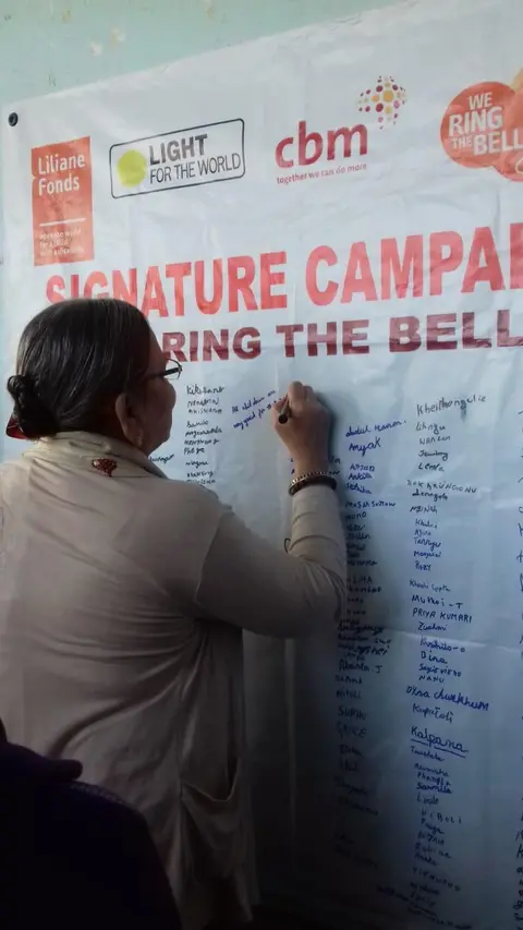 Chief Guest for the 2nd Day of Umang Festival, Smti. Kavita Acharya, signing on the Signature Campaign for 'Ring the Bell' activity for RAISE-NE.