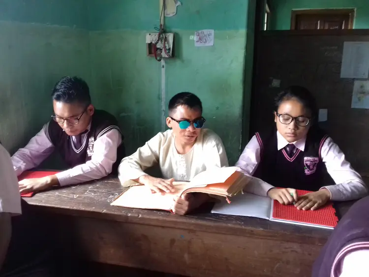 Sir Amos with Nzano and Mhunchumo (all three are visually impaired)